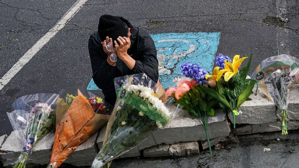 PHOTO: Woojin Kang, 27, cries at the makeshift memorial outside Gold Spa near Acworth, Ga., on March 18, 2021.