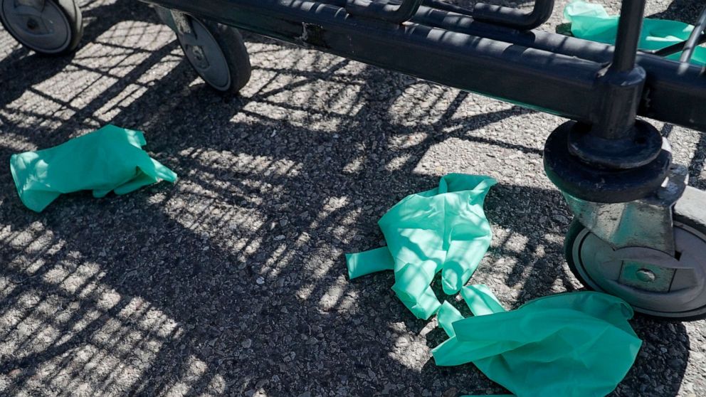 PHOTO:Discarded latex gloves lie on the ground outside of a grocery store in Glenview, Ill., April 5, 2020.