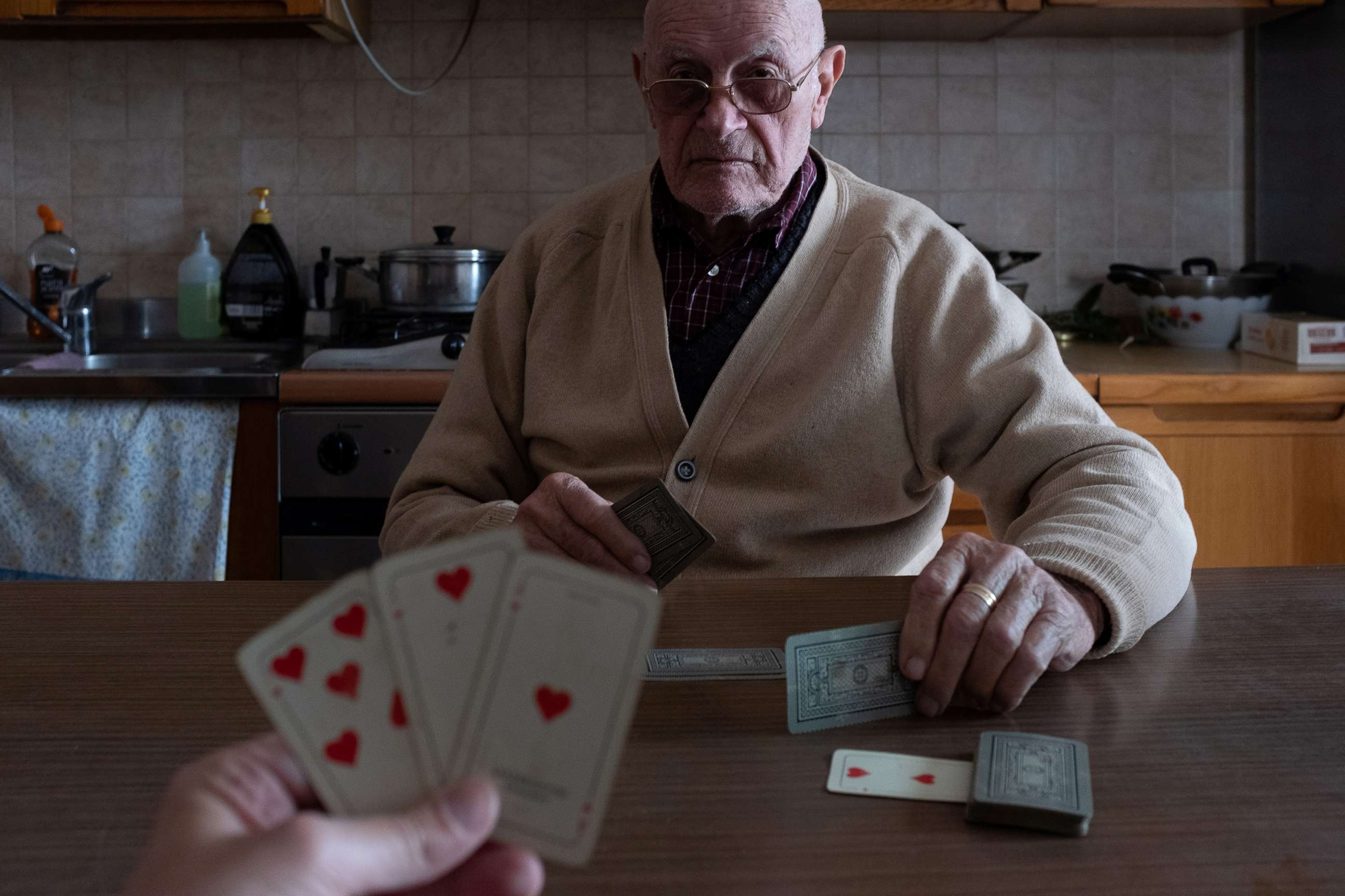 PHOTO: Marzio Toniolo, 35, and his grandfather, Gino Verani, 87, play a game of cards at home, during the coronavirus (COVID-19) outbreak, in San Fiorano, Italy, March 12, 2020.