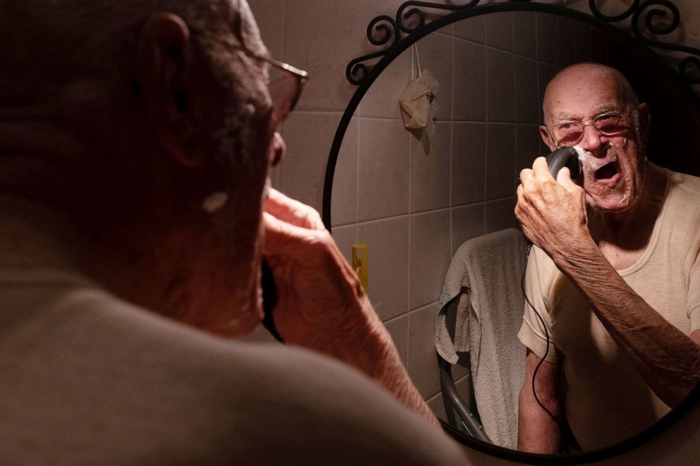 PHOTO: Gino Verani shaves his beard at home, during the coronavirus disease (COVID-19) outbreak, in San Fiorano, Italy, April 13, 2020.