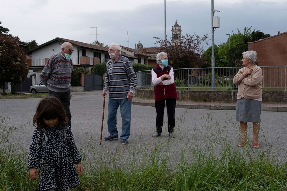 PHOTO: Gino Verani and his wife Ines Prandini practice social distancing during the coronavirus disease (COVID-19) outbreak, in San Fiorano, Italy, April 19, 2020.