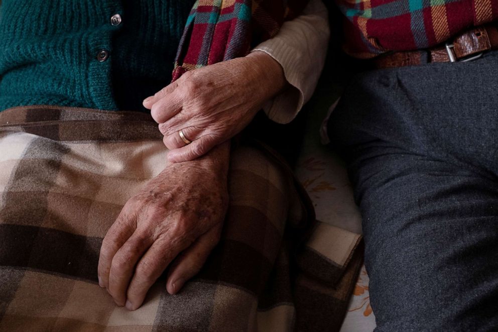 PHOTO: Gino Verani, 87, and his wife Ines Prandini, 85, link arms at home during the coronavirus disease (COVID-19) outbreak, in San Fiorano, Italy, Feb. 29, 2020.