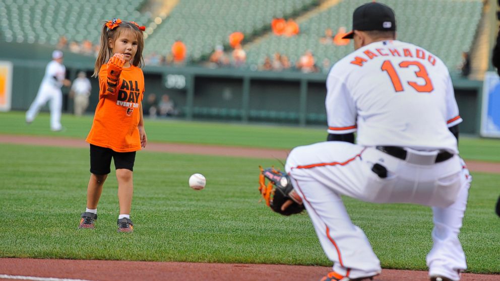 Hailey Dawson, a 5-year-old from Las Vegas, throws the ceremonial first pitch before a game between the Baltimore Orioles and Oakland Athletics on Monday, Aug. 17, 2015, at Camden Yards in Baltimore. Hailey was born with Poland Syndrome. Engineering students at the University of Nevada, Las Vegas created the "Flexy Hand 2" that she wore to throw the ball. 