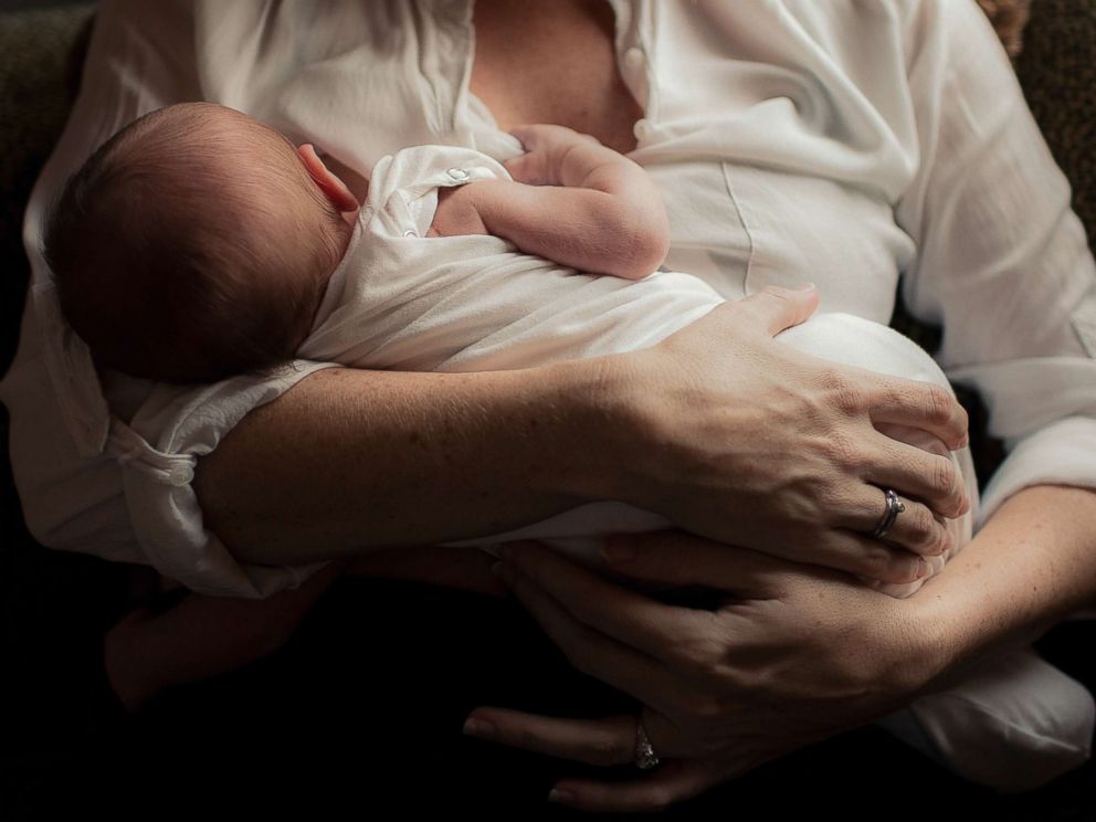 PHOTO: A mom breastfeeds her child.