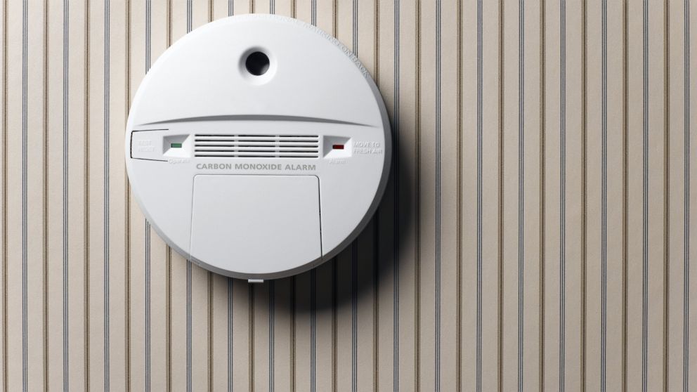 A smoke detector and carbon monoxide alarm mounted on wall.