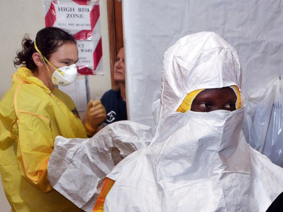 PHOTO: A picture taken on July 24, 2014 shows staff of the Christian charity Samaritans Purse putting on protective gear in the ELWA hospital in the Liberian capital Monrovia.