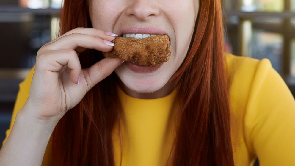 A women eats fried chicken in this undated file photo. 