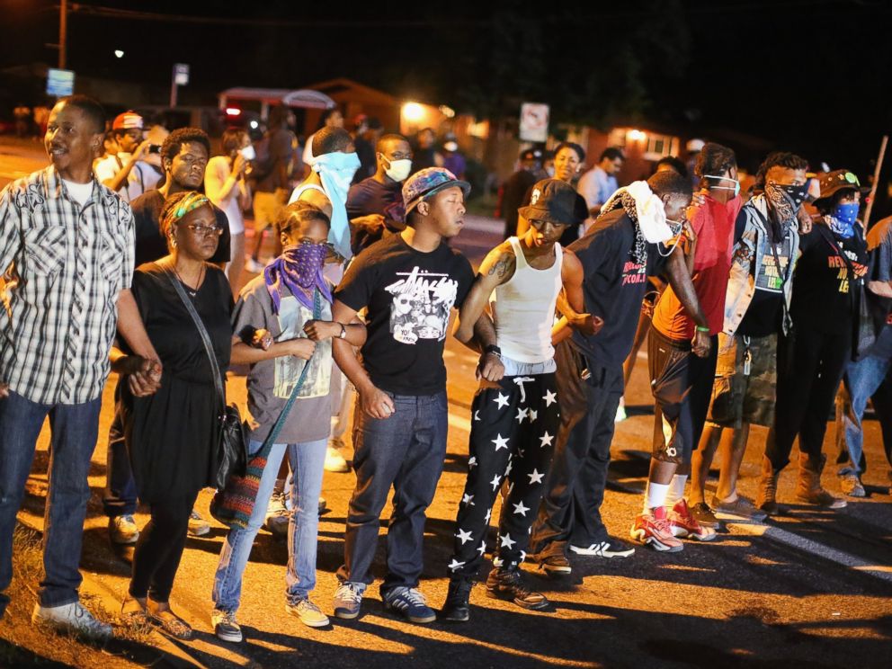 PHOTO: Demonstrators protest the shooting death of teenager Michael Brown on August 13, 2014 in Ferguson, Missouri.