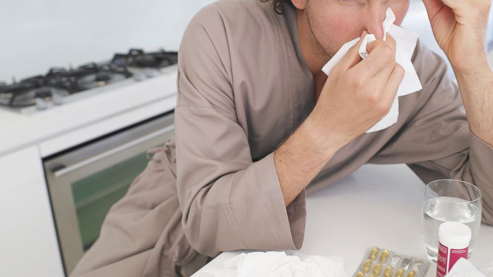 A stock image of a man with the flu. 