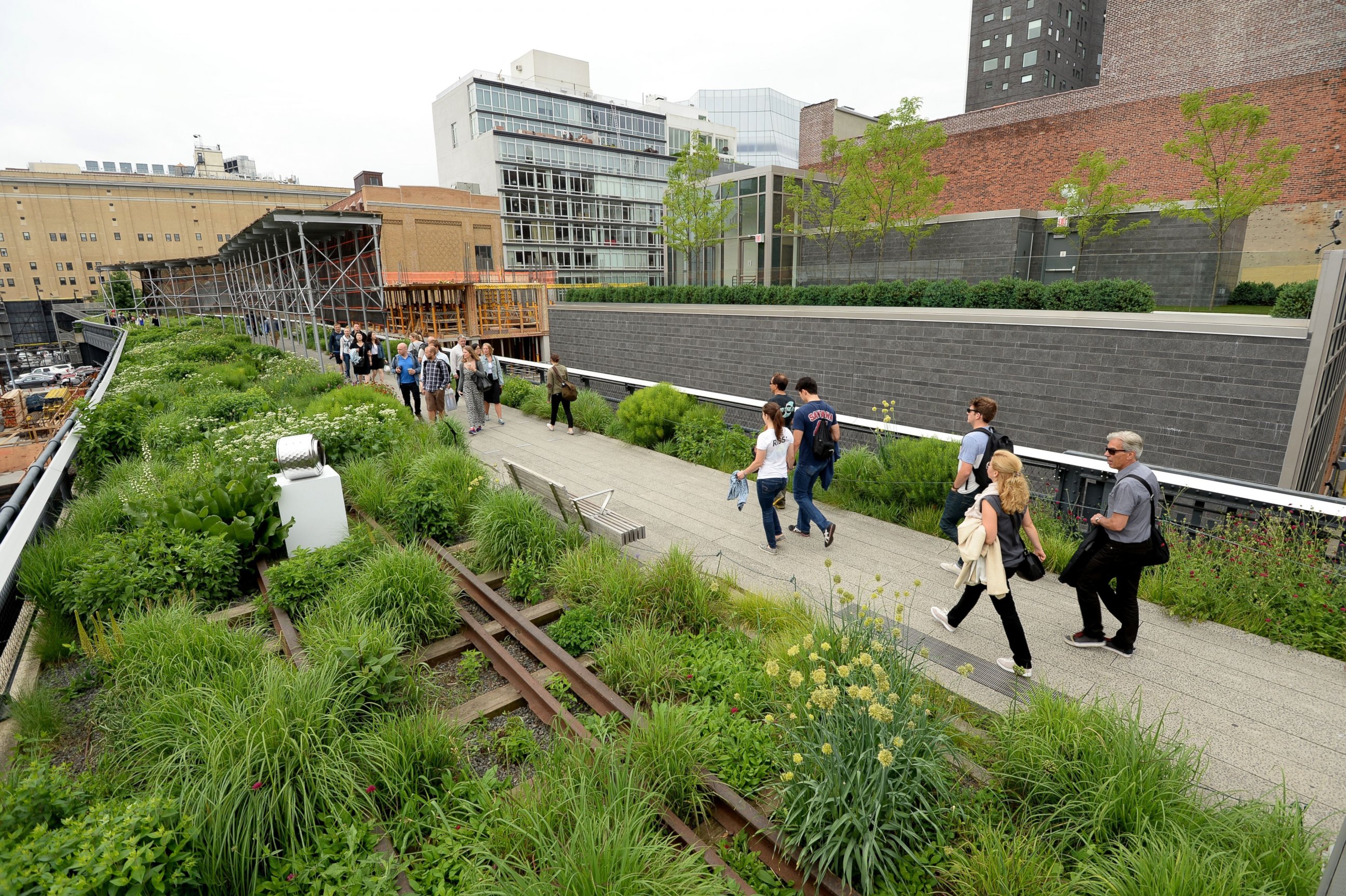 PHOTO: Visitors walk along the High Line on June 11, 2014 in New York.