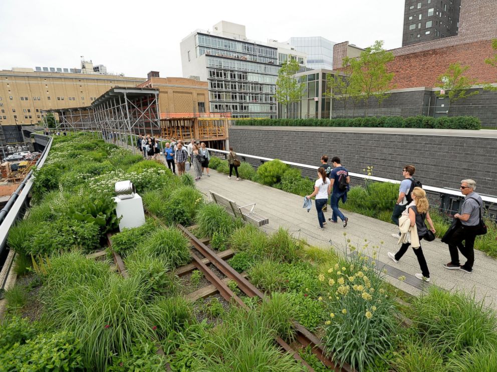 PHOTO: Visitors walk along the High Line on June 11, 2014 in New York.