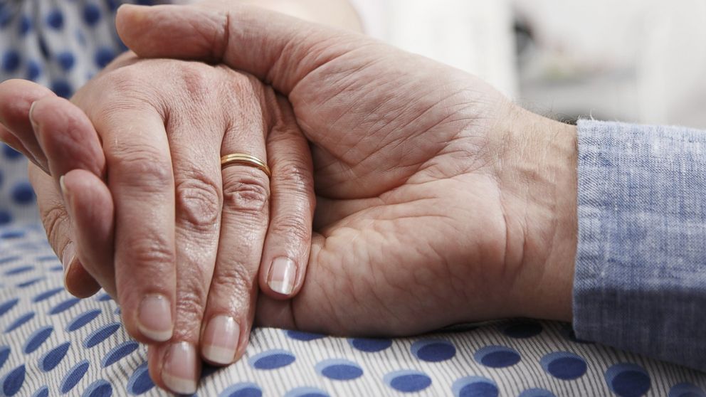 A senior couple holds hands in an undated stock photo.