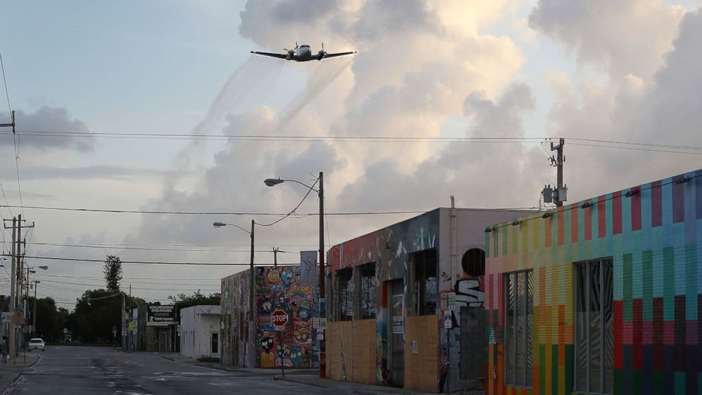 PHOTO: A plane sprays pesticide over Miami's Wynwood neighborhood on Aug. 6, 2016 in Miami.