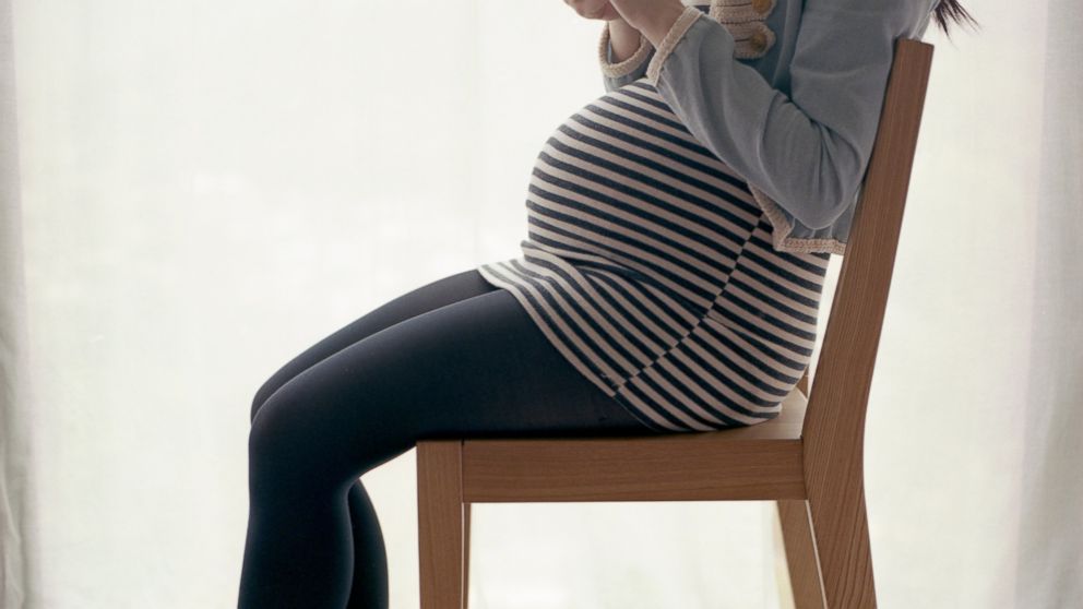 A pregnant woman sitting in this undated stock photo. 
