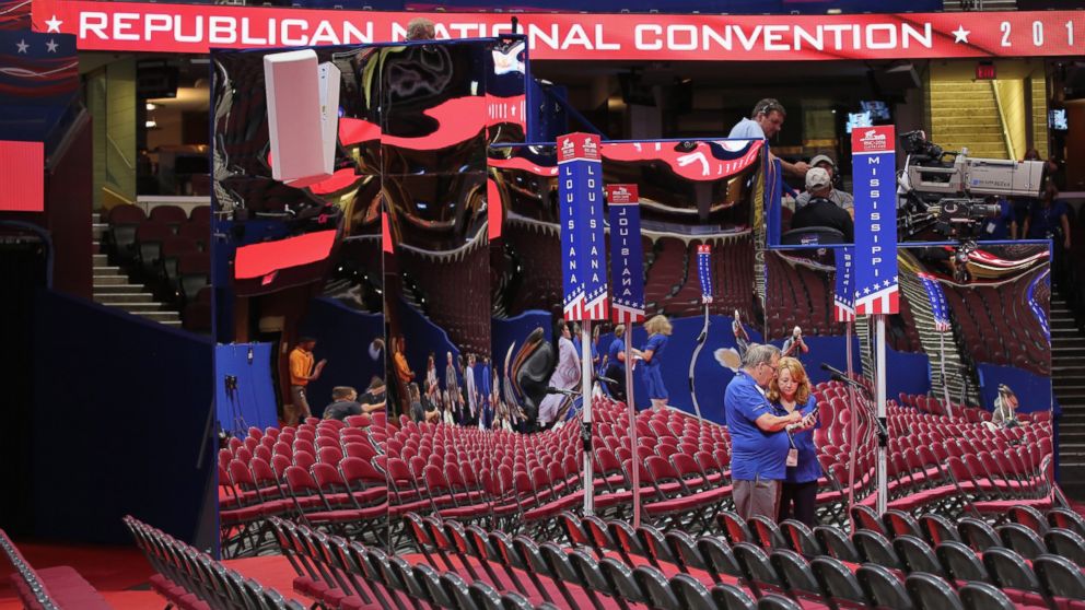Event workers compare photos on the floor of the Quicken Loans Arena ahead of the Republican National Convention, July 16, 2016, in Cleveland, Ohio.