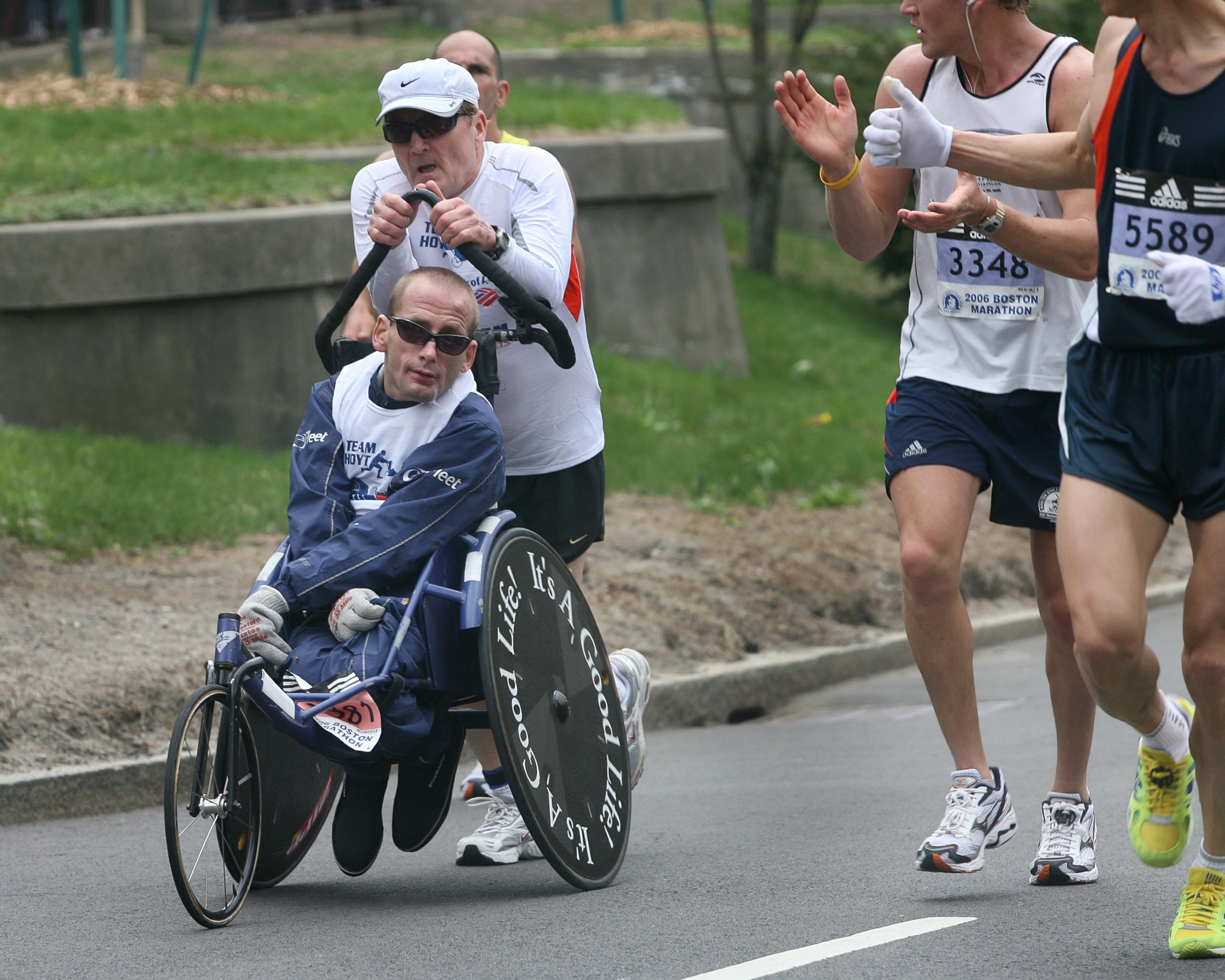 PHOTO: Dick and Rick Hoyt get encouragement from other competitors on Commonwealth Avenue near mile 25.4 during the running of the 110th Boston Marathon on April 17, 2006.