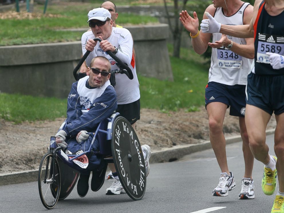 PHOTO: Dick and Rick Hoyt get encouragement from other competitors on Commonwealth Avenue near mile 25.4 during the running of the 110th Boston Marathon on April 17, 2006.