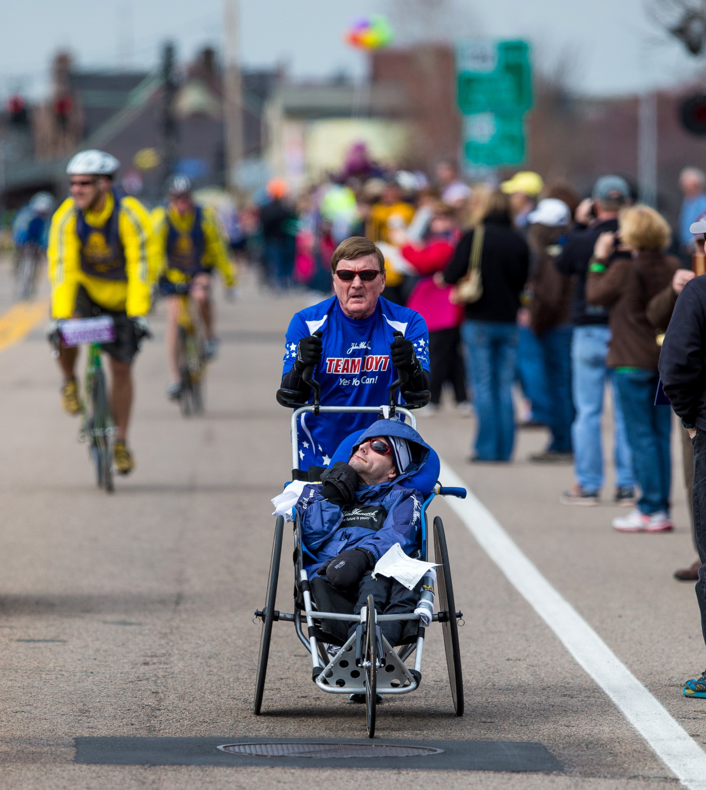 PHOTO: Dick Hoyt pushes his son, Rick Hoyt, in a specialized wheelchair during the 117th Boston Marathon on April 15, 2013.