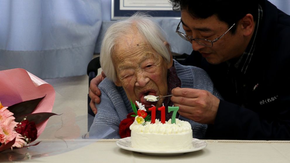 PHOTO: A nursing home employee helps Misao Okawa, who is recognised by Guinness World Records as the world's oldest living person, eat her birthday cake on her 117th birthday celebration at Kurenai Nursing Home on March 5, 2015 in Osaka, Japan.