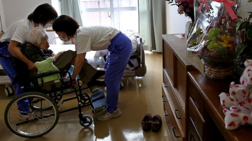 PHOTO: Nursing home staff help Misao Okawa, the world's oldest Japanese woman, get into bed after lunch on her 117th birthday at Kurenai Nursing Home on March 5, 2015 in Osaka, Japan.