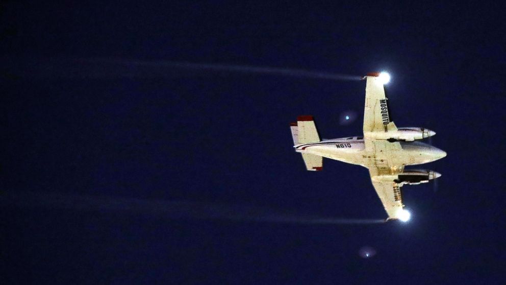 A plane sprays pesticide over the Wynwood neighborhood in the hope of controlling and reducing the number of mosquitos, some of which may be capable of spreading the Zika virus, Aug. 12, 2016 in Miami, Florida.