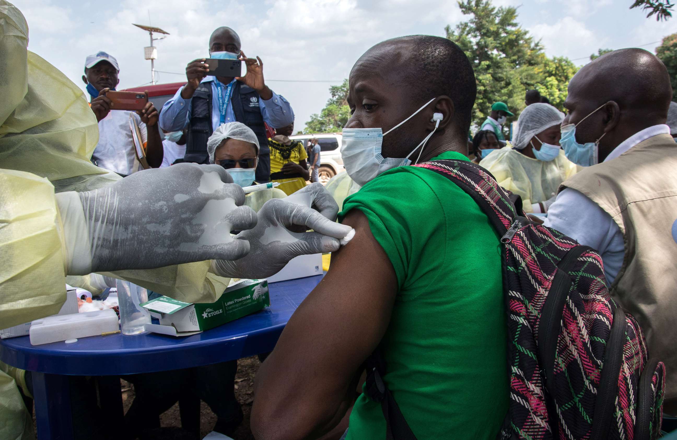 PHOTO: In this Feb. 23, 2021, file photo, a health worker from the Guinean Ministry of Health cleans a suspected contact of an Ebola patient's arm ahead of administering an anti-Ebola vaccine in Gueckedou, Guinea.