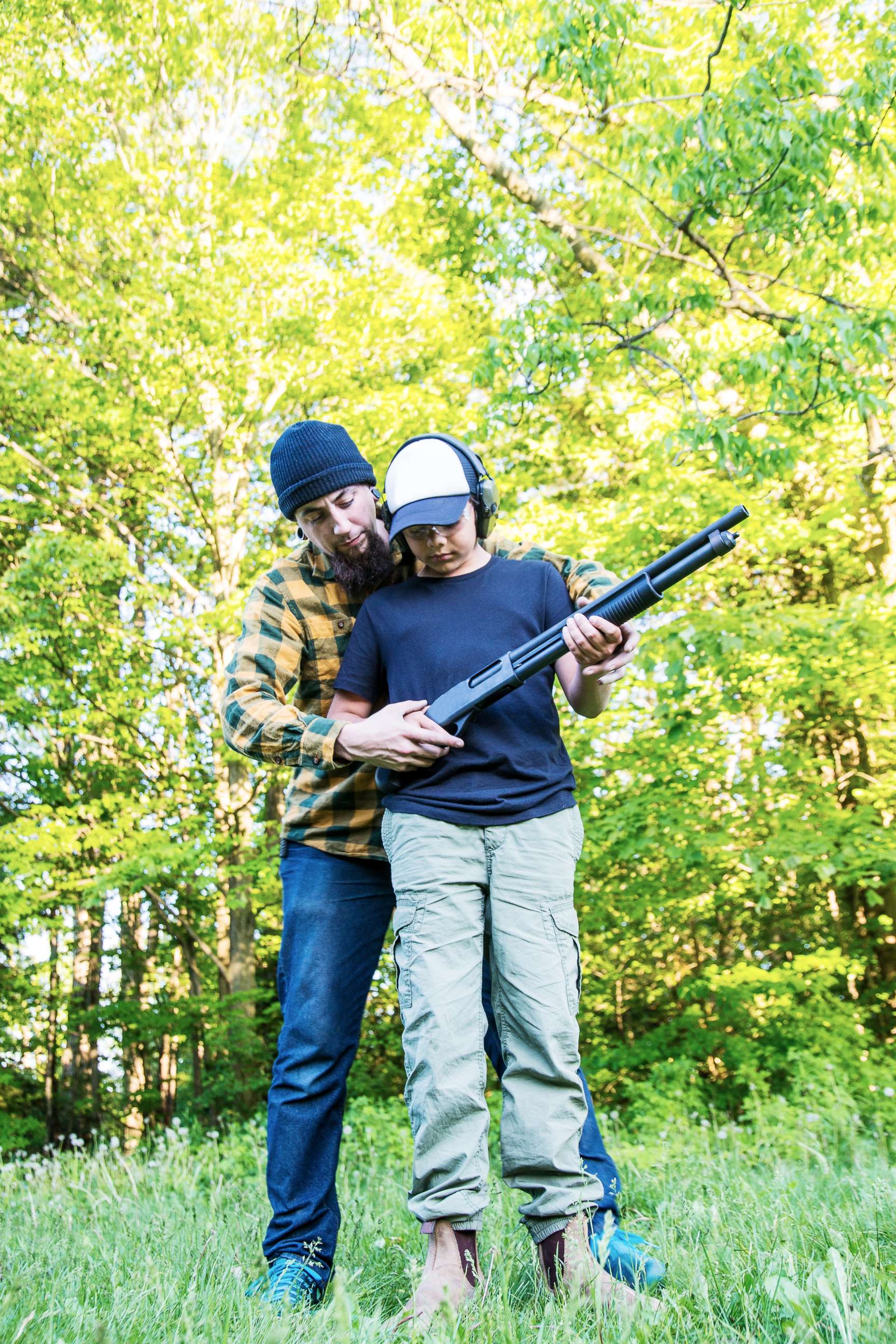 PHOTO: A man teaches a boy how to shoot a rifle in this undated stock photo.