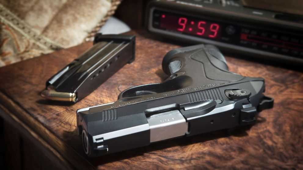 This stock photo depicts a handgun on a nightstand.