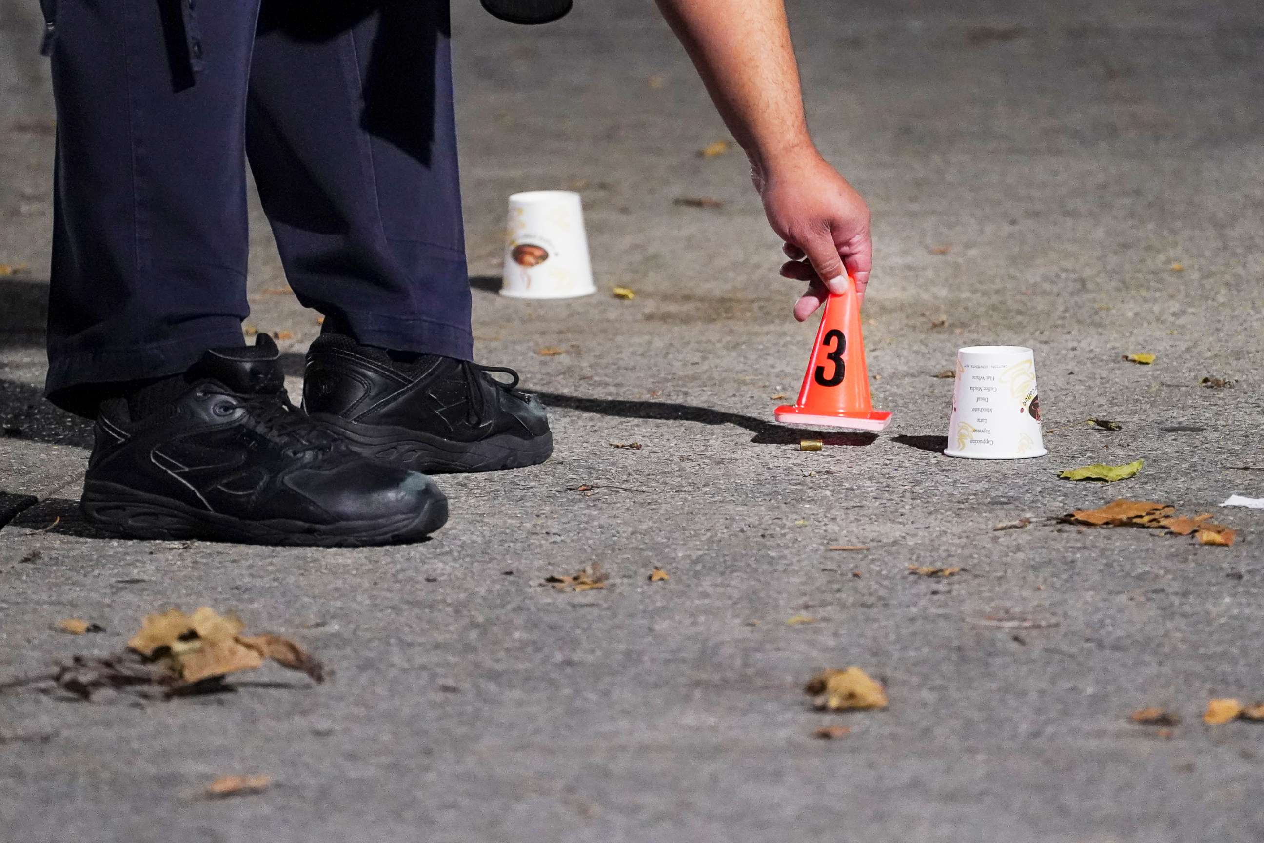 PHOTO: A bullet casing is marked by a New York City Police Department officer at a crime scene where several young men were shot in the Queens borough of New York, Aug.18, 2020.