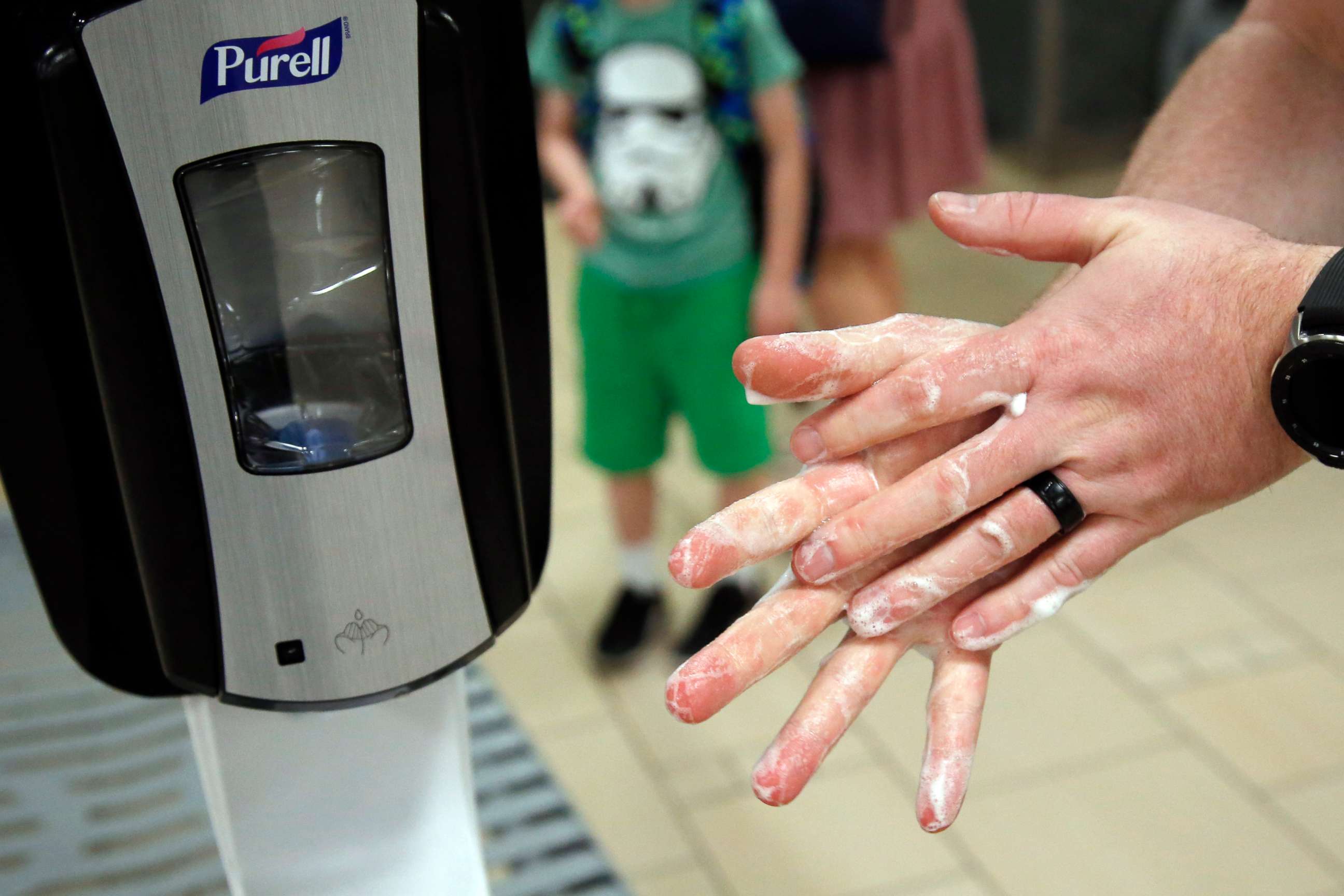PHOTO: A traveller uses hand sanitizer from a dispenser at Sky Harbor Airport in Phoenix, March 17, 2020.