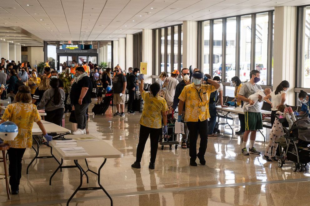 PHOTO: State officials checked to be sure all arriving visitors and residents alike had answered a health questionnaire, had their temperatures taken and shown proof of a negative COVID test, at Honolulu International Airport, Oct. 15, 2020 in Honolulu.