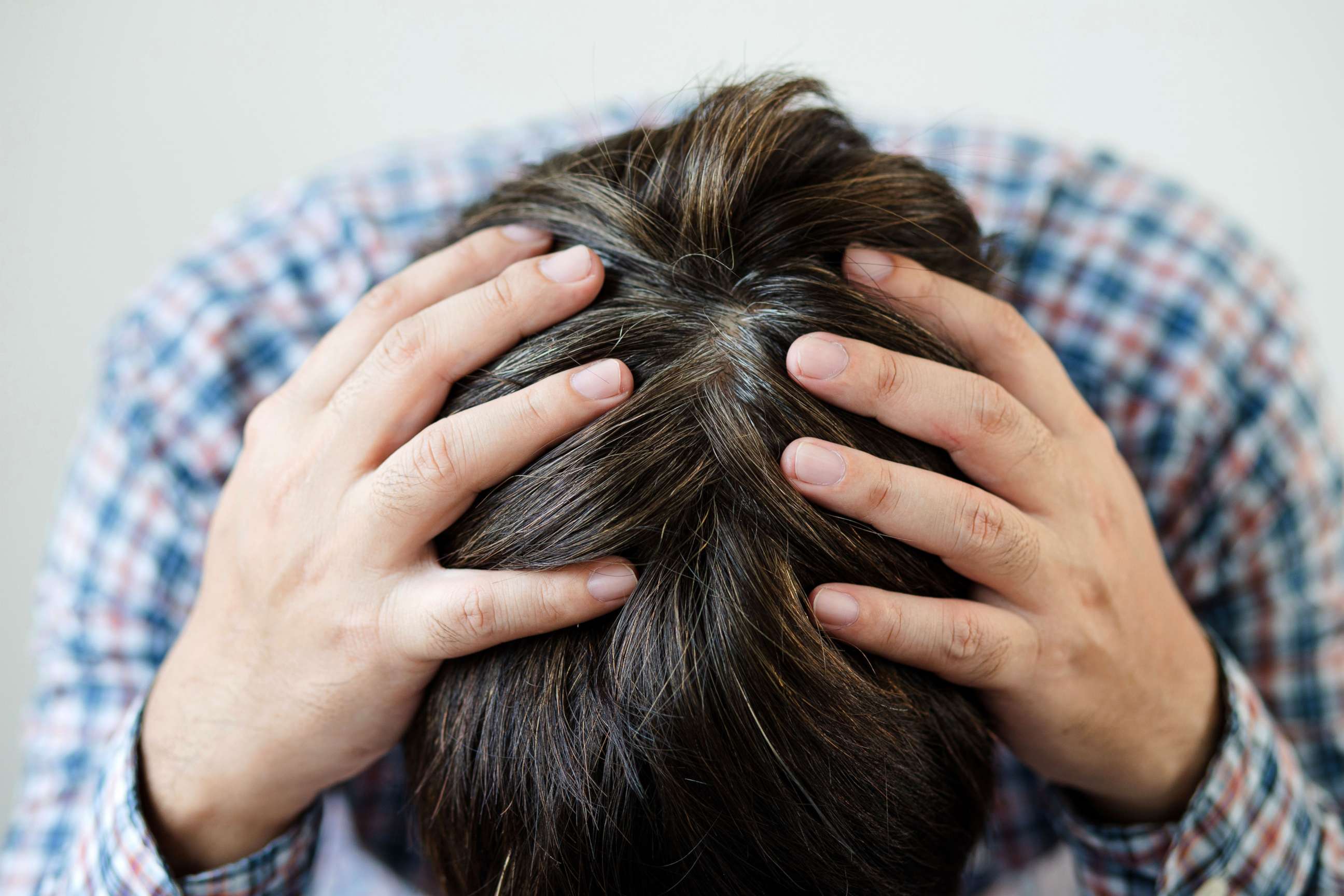 PHOTO: Stock photo of a person holding their head.