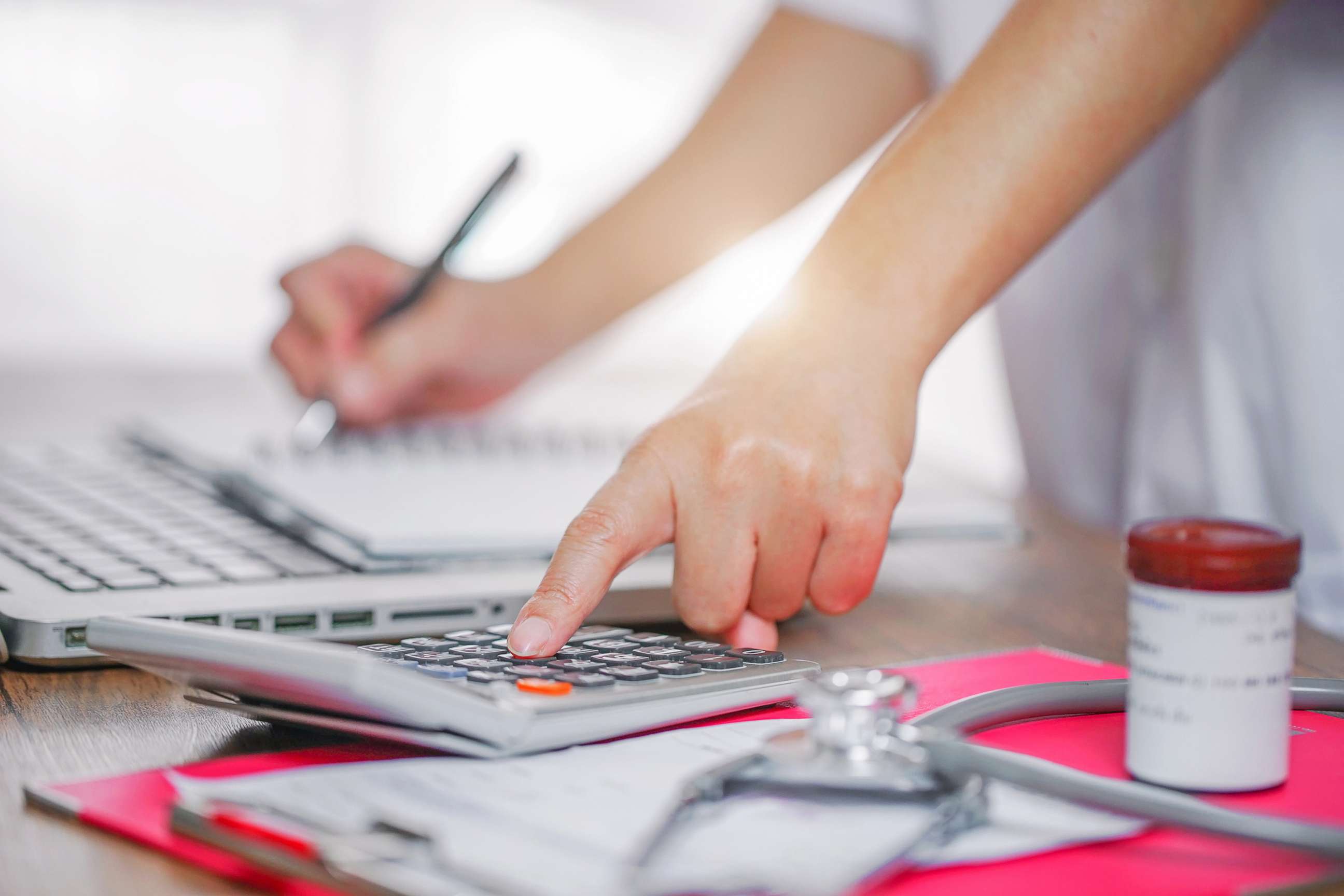 PHOTO: A person uses a calculator in a medical setting in an undated stock photo.