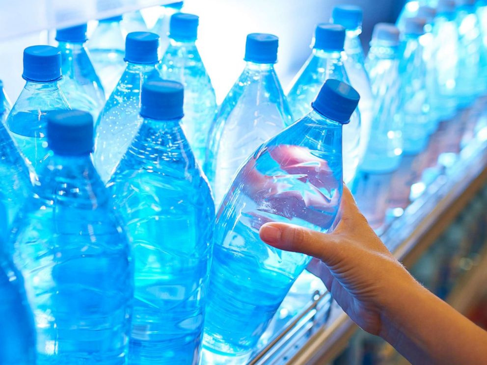 PHOTO: Someone takes a bottle of water from a shelf in an undated stock photo.