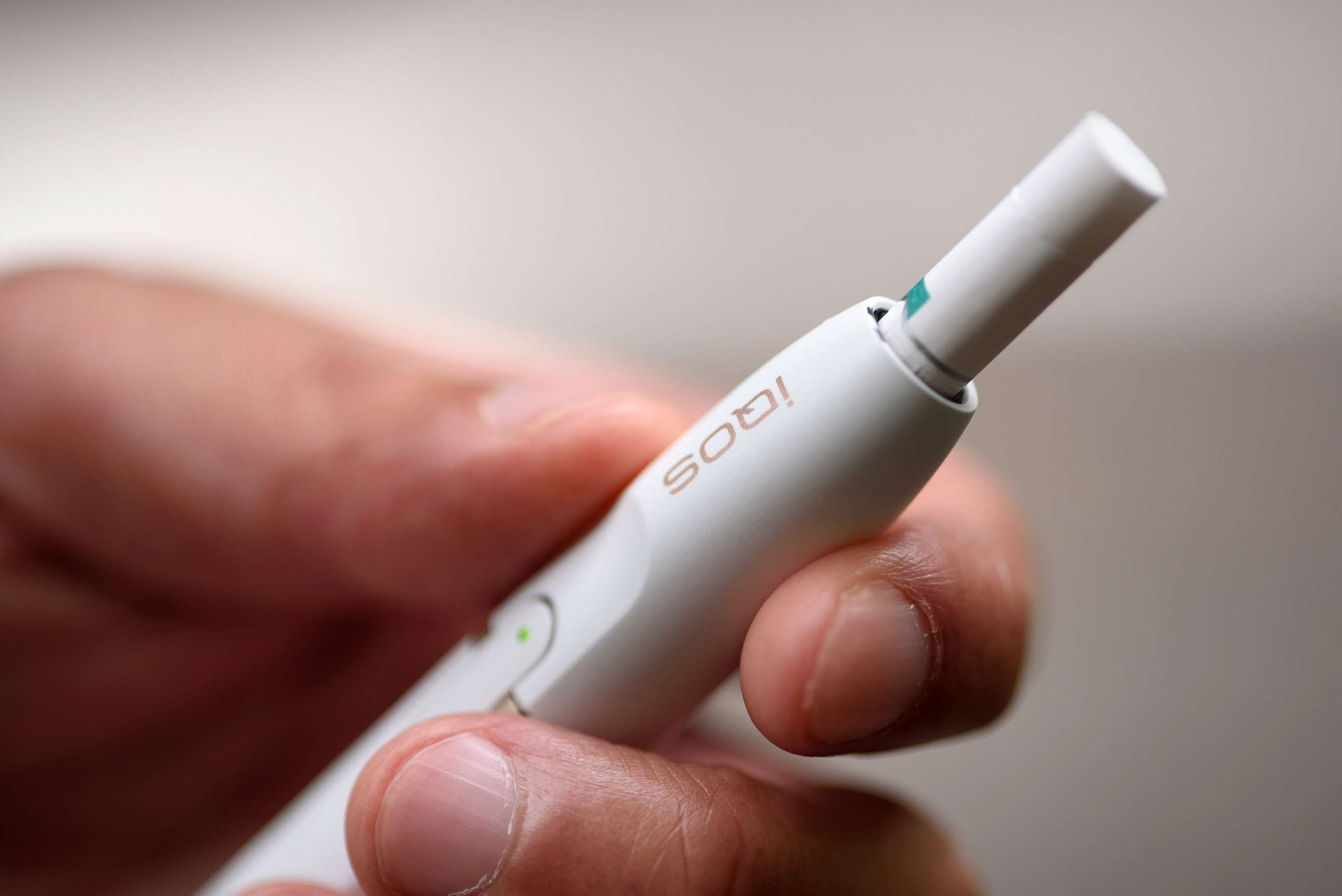 PHOTO: A man holds an iQOS electronic cigarette in Tokyo, Aug. 23, 2016. This product is heated (not burned) and consumed in battery-charged device, seeking to appeal to smokers who want their nicotine fix without the usual smell and smoke. 