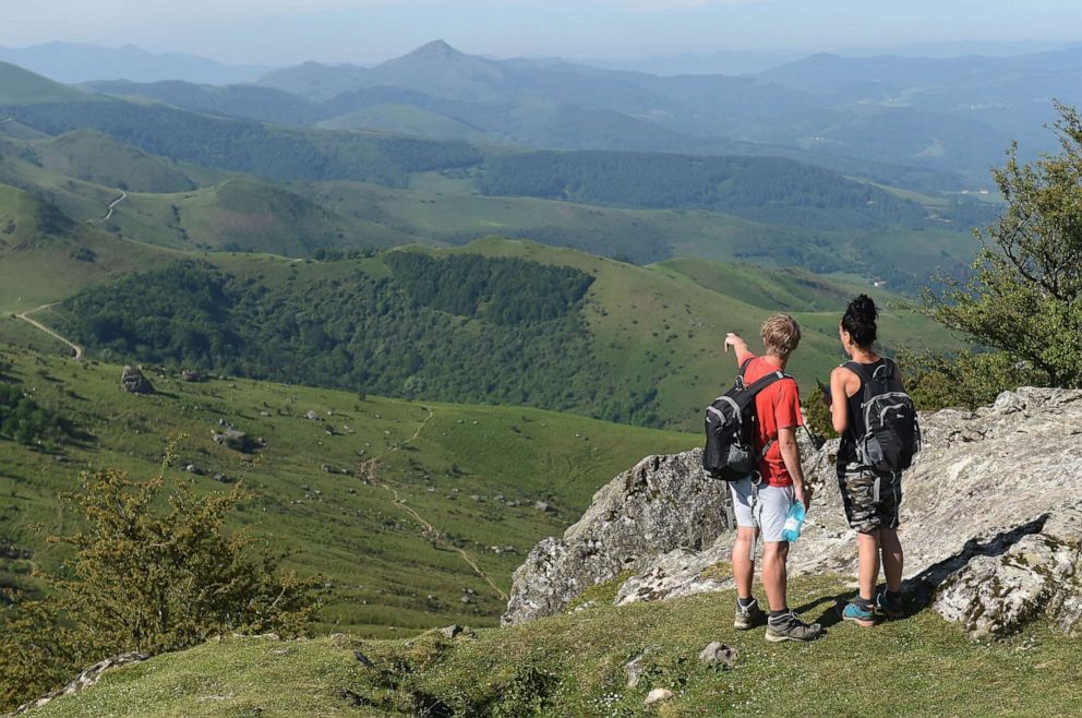 PHOTO: Mountain hikers enjoy the view from the top of the Mondarrain Mount near Itxassou, southwestern France, on May 21, 2020 as France eases lockdown measures taken to curb the spread of the COVID-19.
