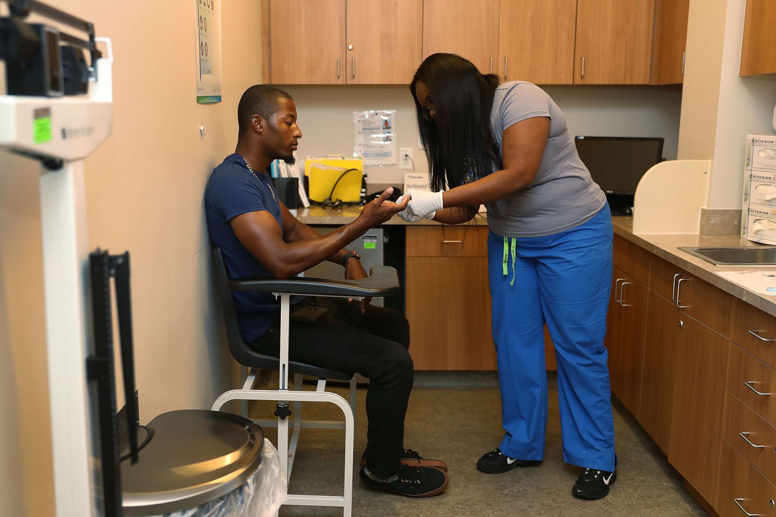 PHOTO: Jamal Wilson has blood drawn from a finger as he receives a free HIV test from a medical assistant in Miami, June 27, 2017.