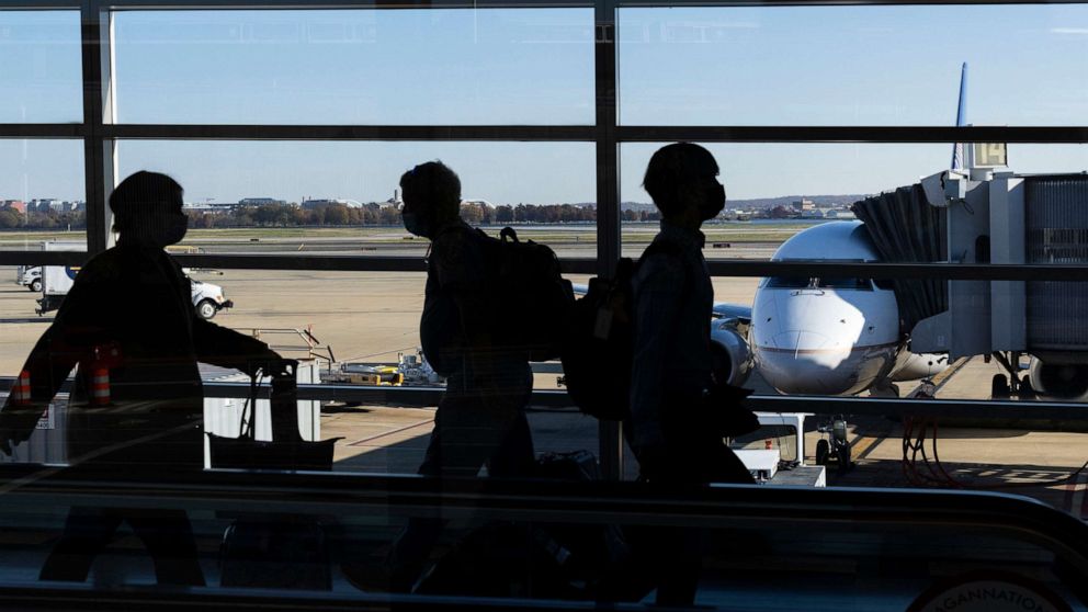PHOTO: Travelers walk through Terminal A at Ronald Reagan Washington National Airport in Arlington, Va., Nov. 23, 2021.