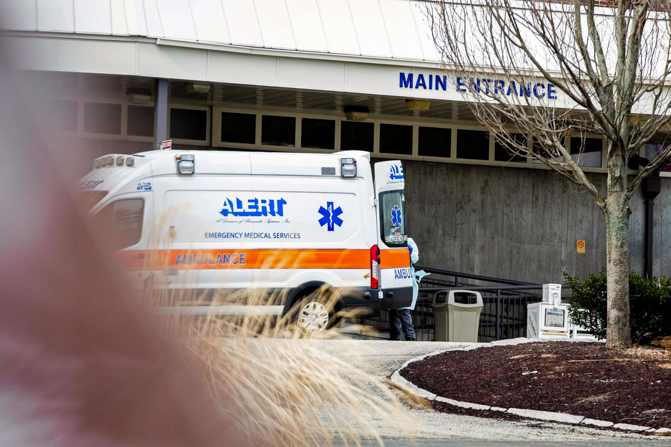 PHOTO:An ambulance and a health care worker with protective equipment arrived at the Holyoke Soldiers' Home, March 31, 2020, in Holyoke, Mass.