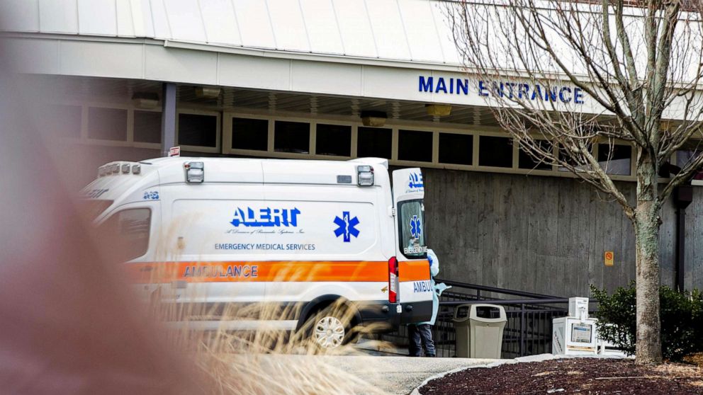 PHOTO:An ambulance and a health care worker with protective equipment arrived at the Holyoke Soldiers' Home, March 31, 2020, in Holyoke, Mass.