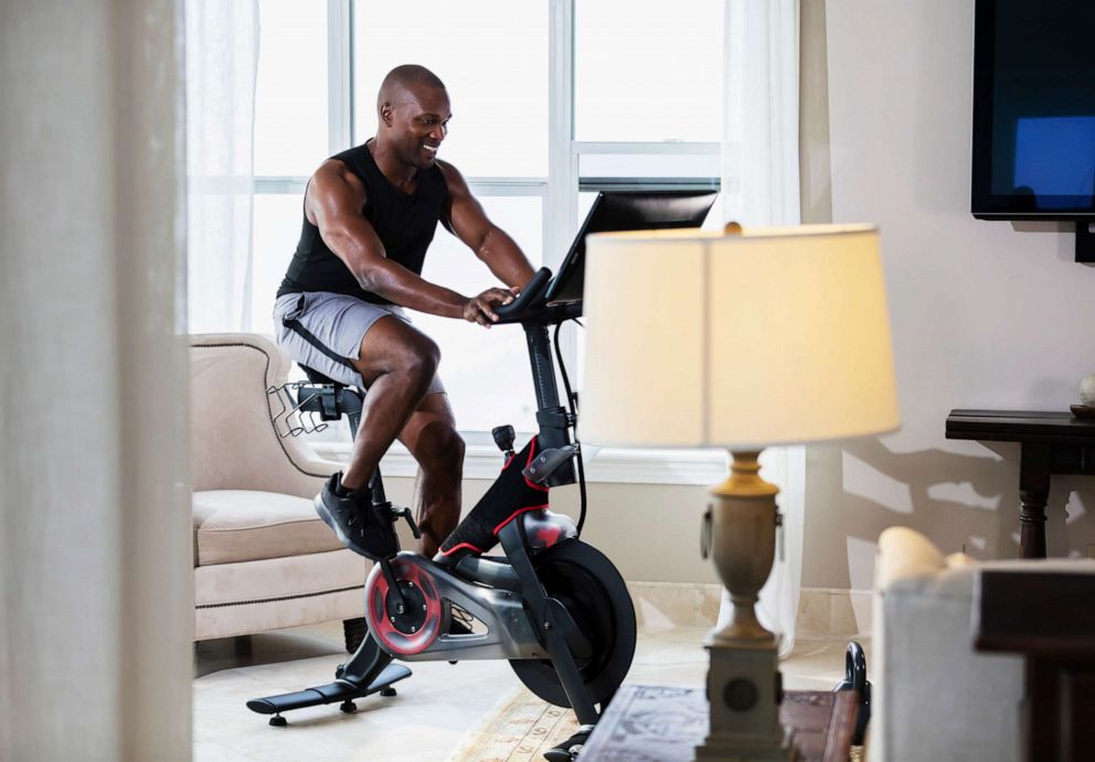 PHOTO: In this undated file photo, a man rides an exercise bike in his living room.
