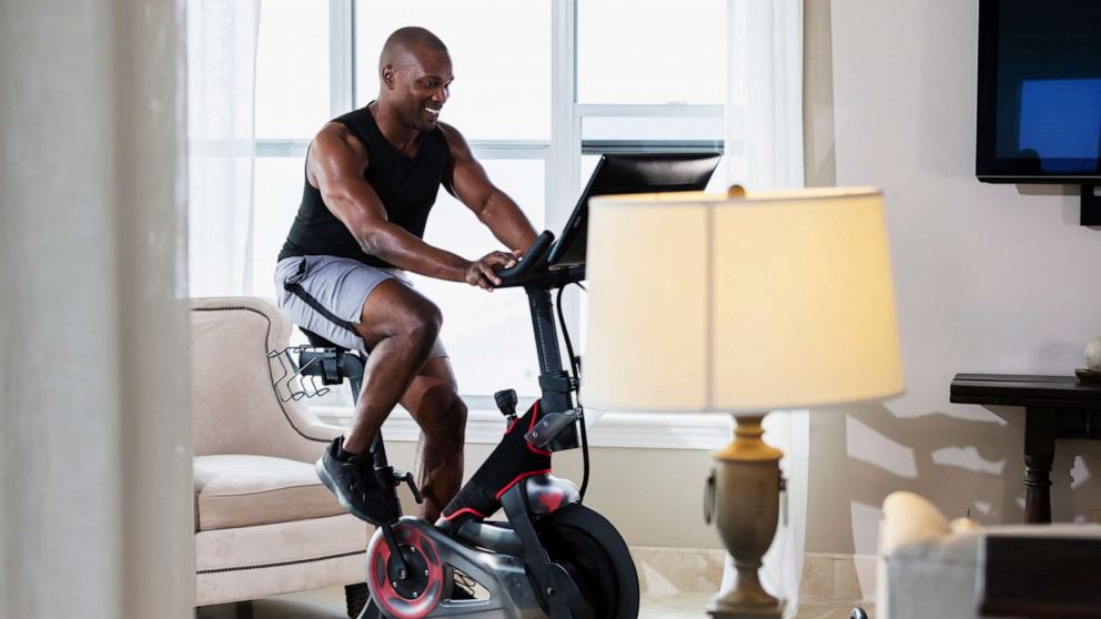 PHOTO: In this undated file photo, a man rides an exercise bike in his living room.