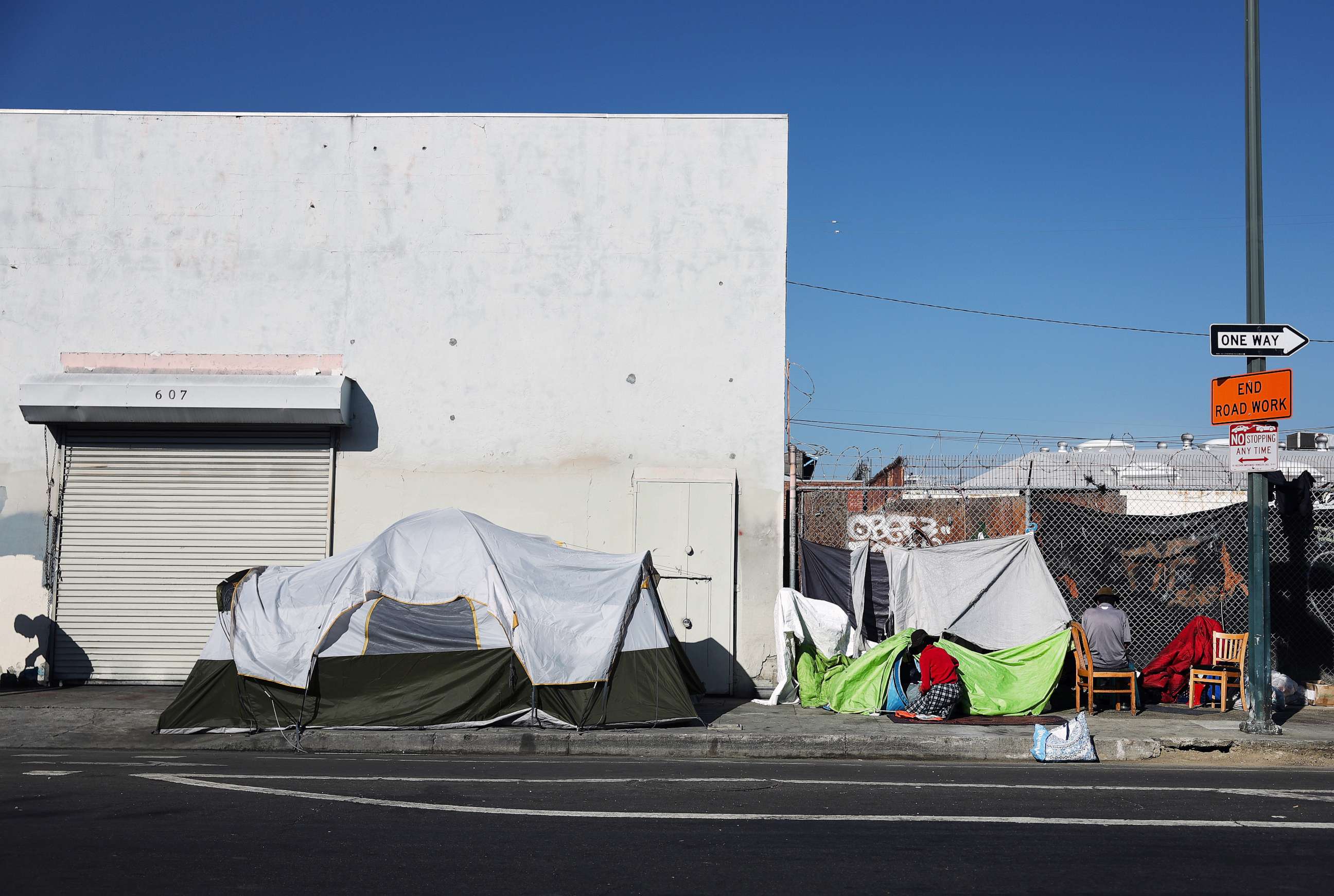 PHOTO: LOS ANGELES, CALIFORNIA - SEPTEMBER 28: People are gathered at a homeless encampment in the Skid Row community on September 28, 2023 in Los Angeles, California.