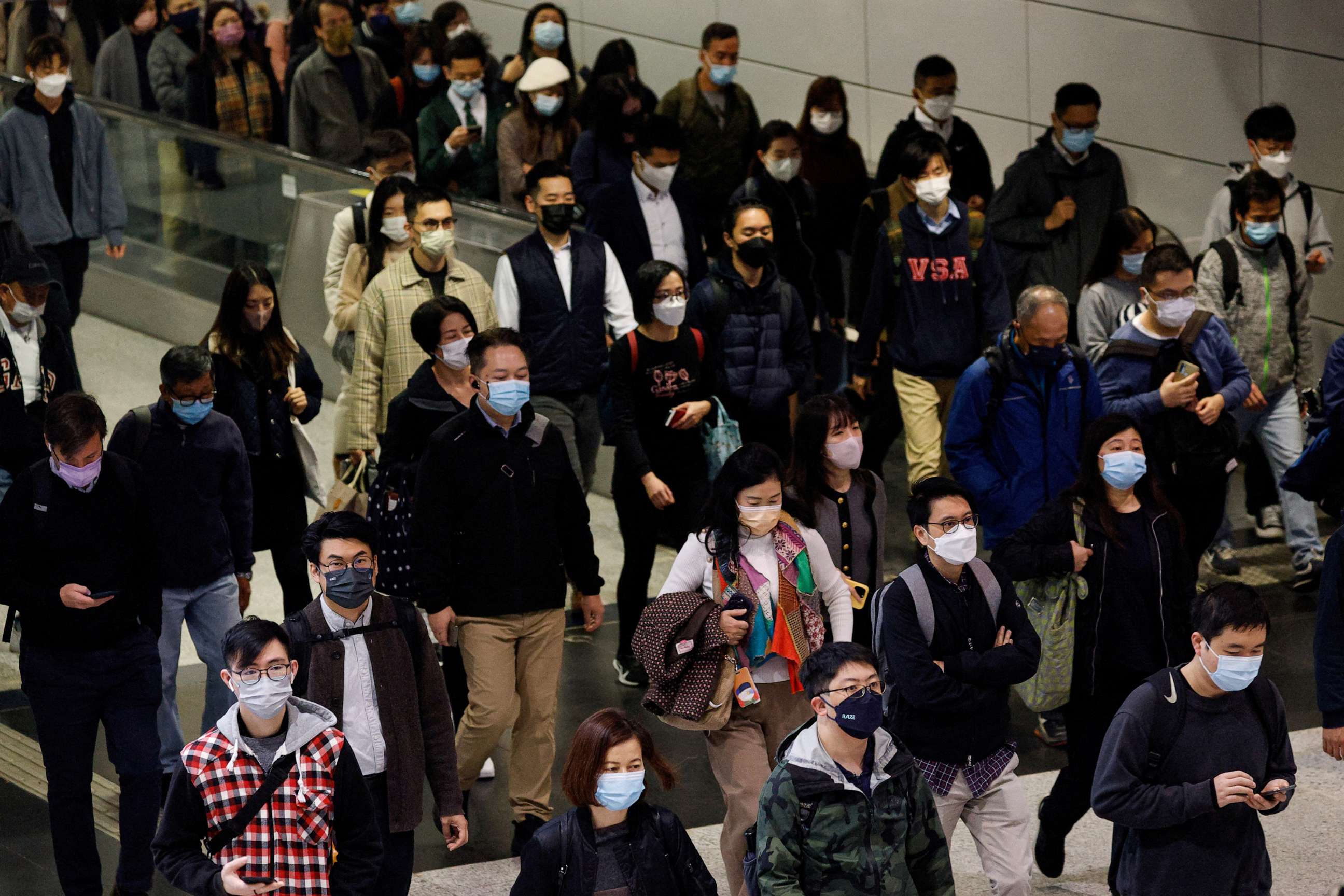 PHOTO: People wear face masks in the MTR station, a day before government gets rid of the mask rule in Hong Kong, Feb. 28, 2023.