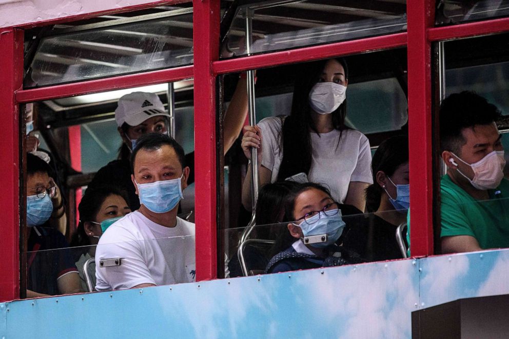 PHOTO: Commuters wear face masks as they travel on the top deck of a tram in Hong Kong on July 10, 2020, as the city experiences new local outbreaks of COVID-19.