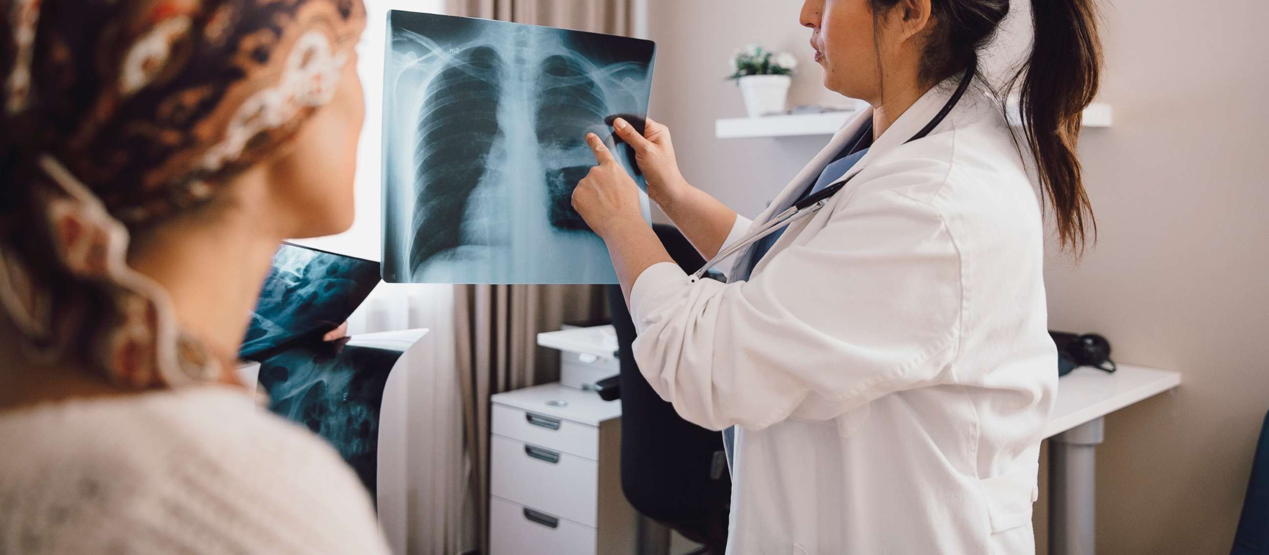 PHOTO: A doctor shows an x-ray to a woman in an undated stock photo. 