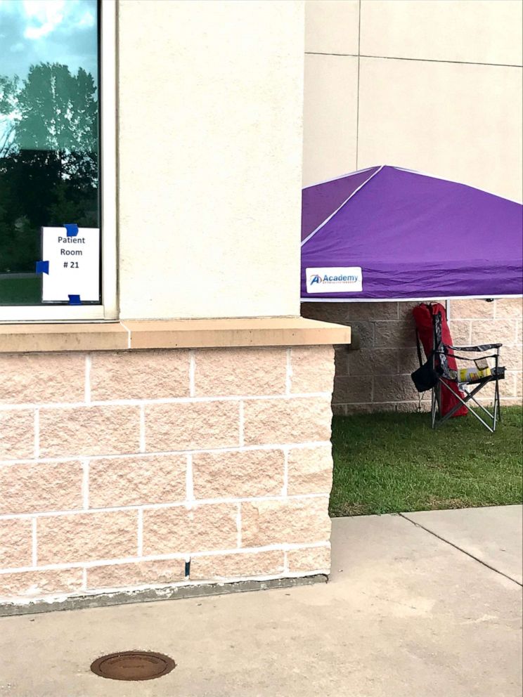 PHOTO: Folding chairs outside the hospital’s windows allow families and friends to see their loved ones battling COVID-19.
