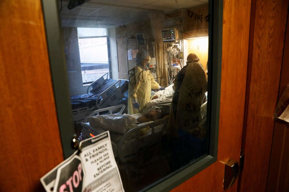 PHOTO: Army Critical Care Nurse, Captain Edward Rauch Jr., left, tends to a Covid-19 patient on a ventilator at Beaumont Hospital in Dearborn, Mich., Dec. 17, 2021.