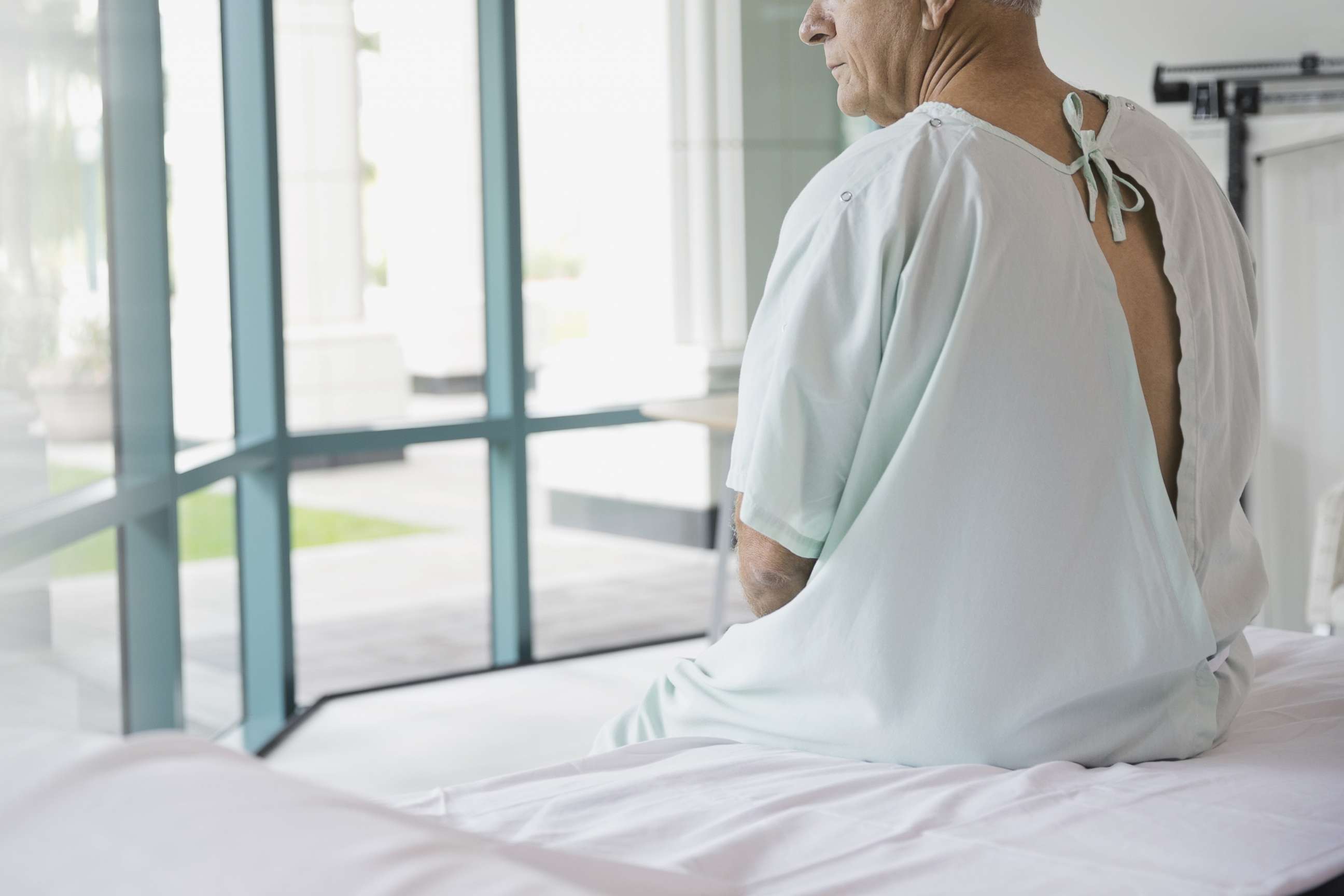 PHOTO: A man is pictured in a doctor's office in a hospital gown. 