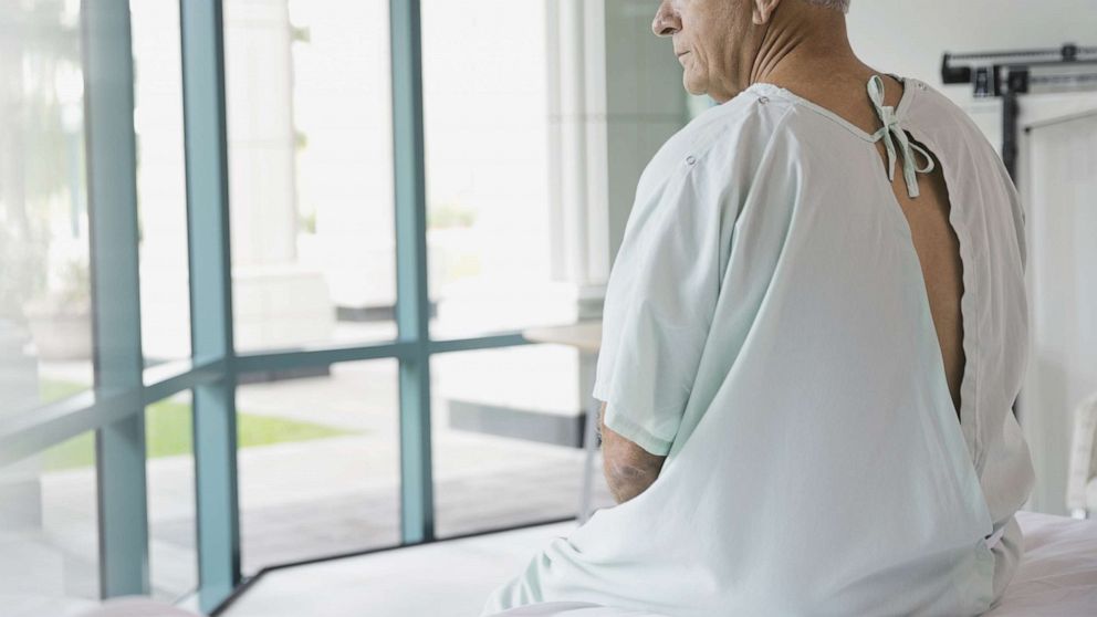 PHOTO: A man is pictured in a doctor's office in a hospital gown. 